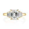 Caroline ring featuring a 1.54ct I/VVS2 GIA certified emerald cut diamond with 0.40ctw baguette cut accent diamonds set in an 18K yellow gold mounting, front view.