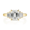 Caroline ring featuring a 1.54ct I/VVS2 GIA certified emerald cut diamond with 0.40ctw baguette cut accent diamonds set in an 18K yellow gold mounting, front view.