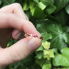 18K yellow gold ring with bezel set marquise cut rubies and round diamonds