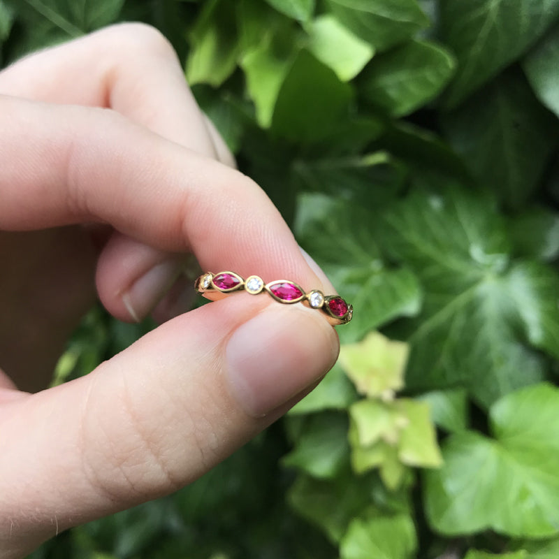 18K yellow gold ring with bezel set marquise cut rubies and round diamonds