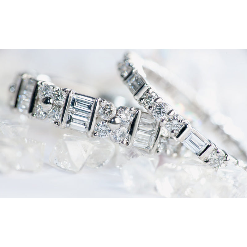 Two Suwa platinum eternity bands with baguette and round brilliant cut diamonds