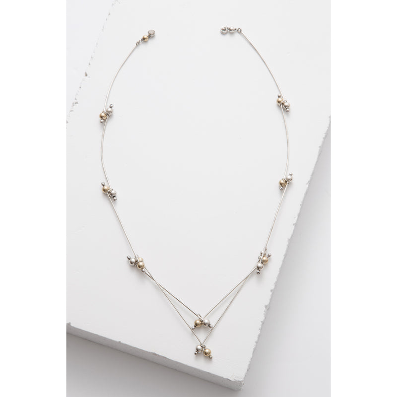 Zuzko v neck necklace shaped in double V pattern with tiny gold and silver beads