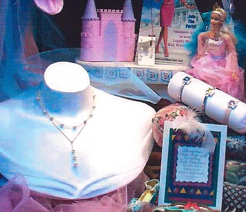 Window display with necklaces and Barbie doll