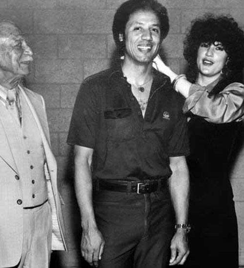 Sid Thal watching as Joy Thal puts a necklace on Lenny Wilkens after the 1979 Super Sonics win.