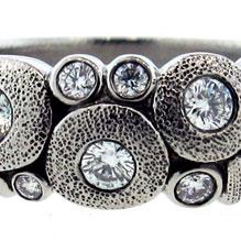 Closeup photo of a platinum and diamond Alex Sepkus ring
