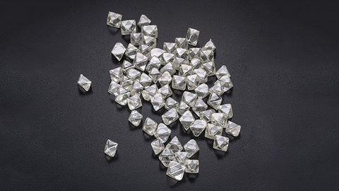 Pile of octahedron diamonds on a black background.