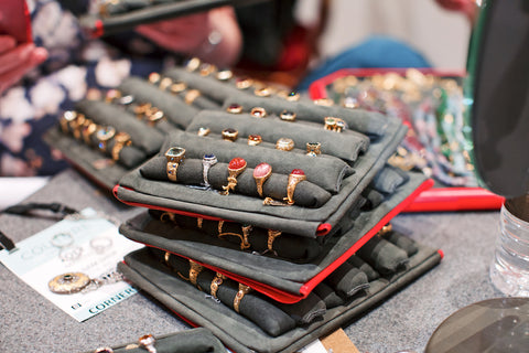 Stacks of Alex Sepkus rings on trays