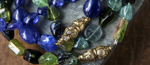 Alex Sepkus green and blue gemstone necklaces on wood