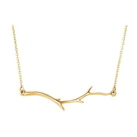 yellow gold branch necklace on white background