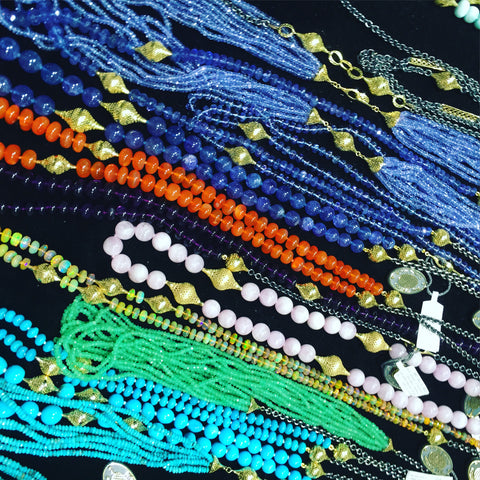 Numerous strands of necklaces by ray griffiths. Gem stones and 18k yellow gold pieces.
