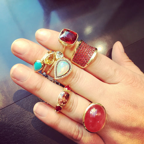 Ray Griffiths 18k yellow gold crown work rings. Multiple rings in many colors and sizes on fingers