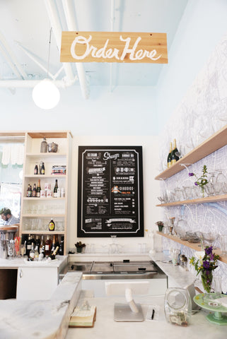 Shug's Soda Fountain menu and counter with white motif