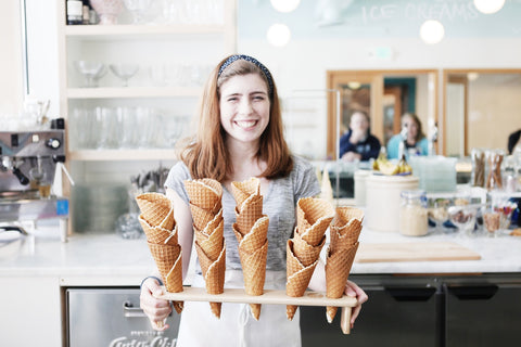 Shug's Soda Fountain employee holding ice cream cones