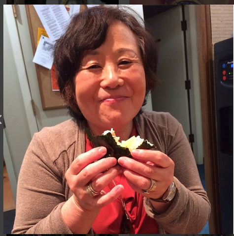 Mariko eating a pocket of rice. 