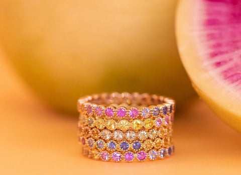 Yellow gold rainbow sapphire rings on a yellow background