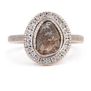 Todd Reed raw diamond ring with white diamond halo around. Set in white metal.