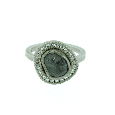 Todd Reed raw diamond with white diamond halo around it. Set in white metal.